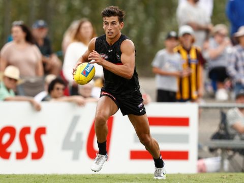 Nick Daicos runs with the footy tucked under his arm