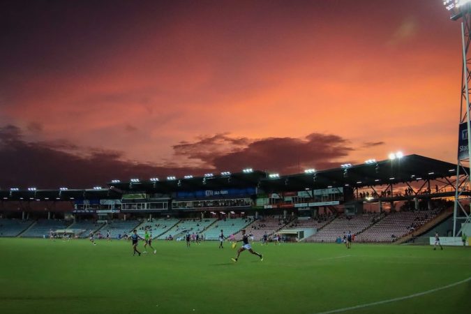 A match is seen being played at TIO Stadium during sunset.