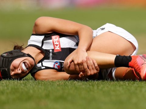 Collinngwood AFLW player Britt Bonnici lays prone after injuring her ACL in 2022
