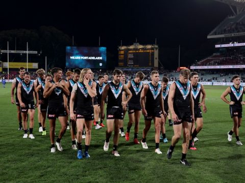 Sad Port Adelaide players leave the Adelaide Oval field together