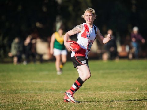 Transgender woman in action on the football field