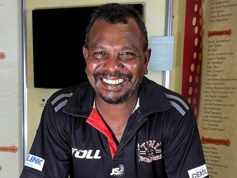 Willie Rioli Senior smiles at the camera wearing a Tiwi Bombers shirt.