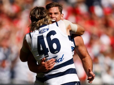 Tom Hawkins and Mark Blicavs embrace after a goal was kicked in the 2022 AFL grand final.