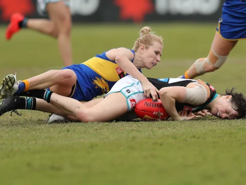 Ebony O'Dea lies on the ground after being tackled by Dana Hooker of the Eagles