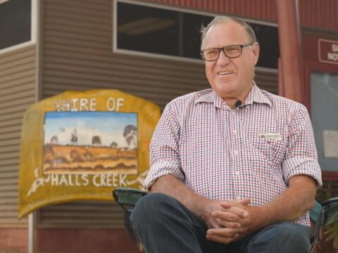 Malcolm Edwards sitting in front of the shire offices.