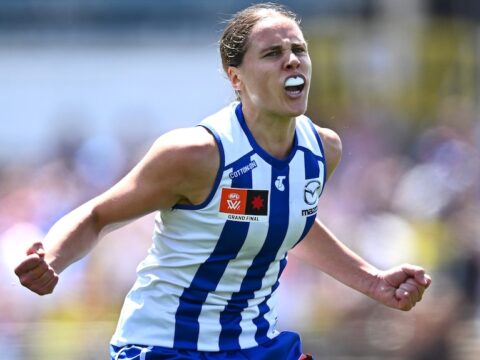 A Kangaroos player pumps her fists as she celebrates a goal in the AFLW grand final.